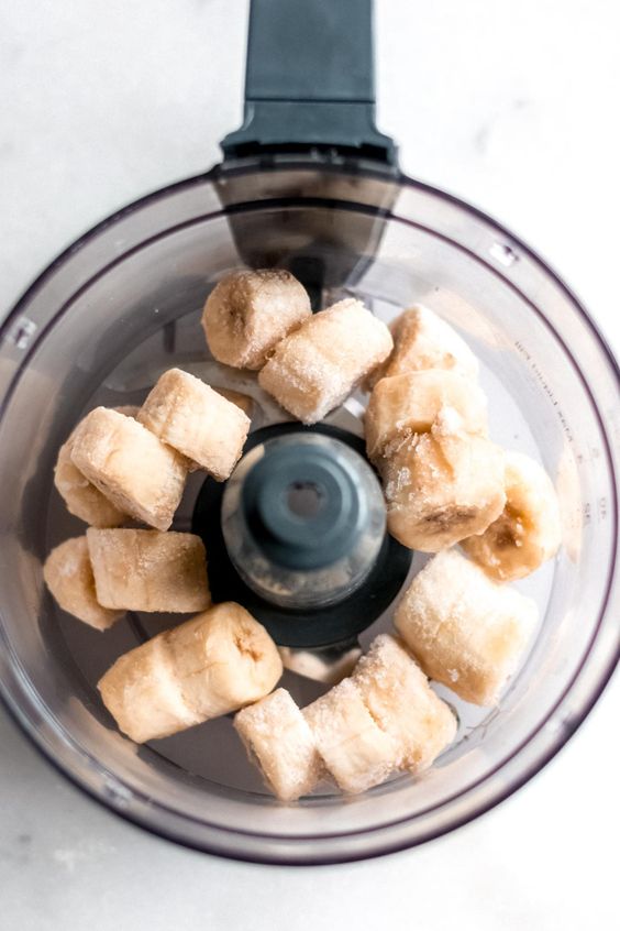 food processor with chopped frozen banana